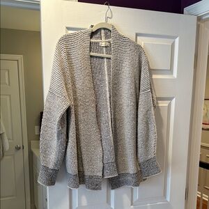 White & grey sleeping on snow sweater